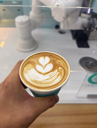 COFE+ robotic coffee kiosk crafts a perfect latte art, showcasing precision automation as a leading robot coffee kiosk supplier.